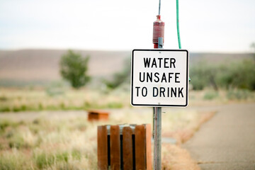 faded water unsafe to drink sign at a camp site
