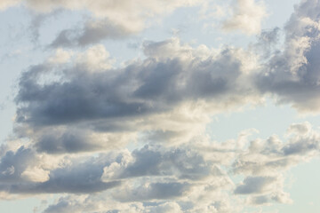blue clouds with sun large clouds background