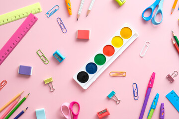Schoool stationery on pink background. Back to school concept. Flat lay, top view.
