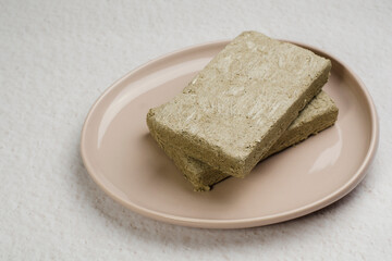 Sunflower halva. Halva is an oriental sweetness made from pounded sunflower seeds and caramel mass (sugar). Halva refers to the confectionery of the national oriental cuisine. Minimalism.