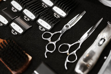 beautiful layout of hairdresser accessories on black towel