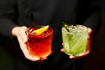 summer red and green lemonade - sangria and mojito on black background