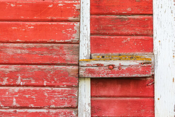 Peeling red paint on a weathered old barn.