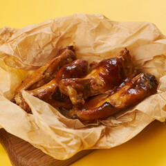 fried chicken wings on craft paper and yellow background