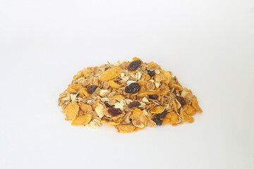 Healthy muesli with oat flakes, nuts and raisins isolated on white background.