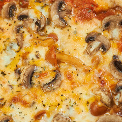 rustic pizza with mushrooms on wooden board and yellow background
