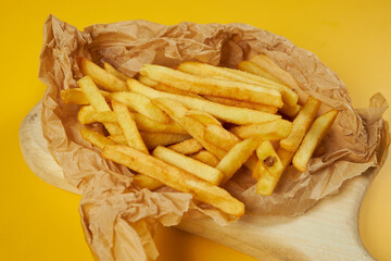 french fries on craft paper and yellow background