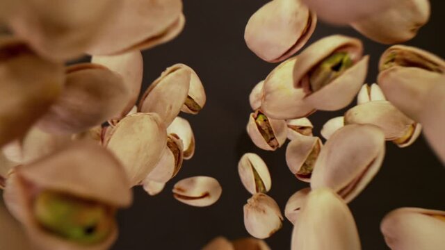 Super Slow Motion Shot of Fresh Roasted Pistachio Nuts Flying Towards Camera at 1000 fps.