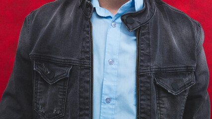 Jeans jacket and blue shirt worn by a man