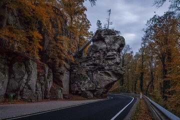 road through Mullerthal at autumn evening with rock formation near Berdorf, Luxembourg