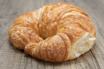 Plain croissant roll is textured with flakey brust for a baked treat delight