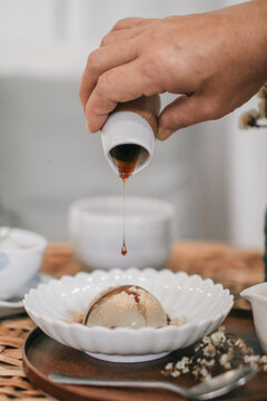 Mizu Shingen Mochi or Japanese Water Cake With Kinako or Soy Powder and Kokumitsu or Syrup. Japanese style dessert with decoration. Raindrop Mizu Mochi is a popular dessert in Japanese, no calorie.