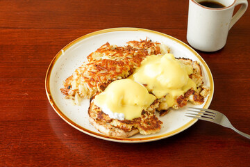 Crab cake benedict with hashed brown potatoes