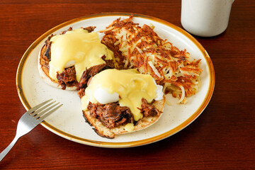 Brisket benedict with hashed brown potatoes