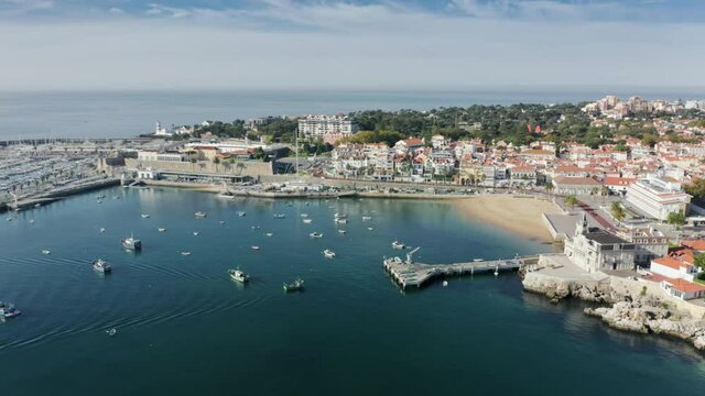 Cascais, Portugal, Europe. Picturesque fishing town washed with the ocean. Aerial footage of beautiful holiday destination with boats and yachts. High quality 4k footage