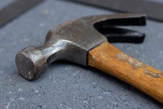 Steel hammer on stone background