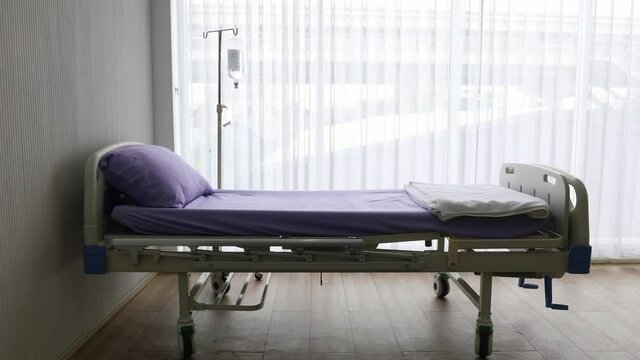 Panning technic video, patient bed in room with white curtain and calm environment. Concept of health care and medical service business.