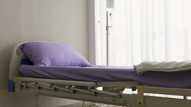 Left to right panning technic video, patient bed in room with white curtain and calm environment. Concept of health care and medical service business.