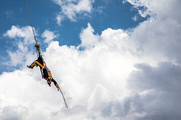 Man in the flying pole dance in Guatemala, in a blue sky