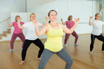 Fototapeta na wymiar Aged European women are dancing during a fitness training session