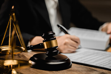 Law firm office, Selective focus judges gavel, businesswoman or female lawyer making contract paper with law book,.scales of justice, document legal, justice advice service concept.