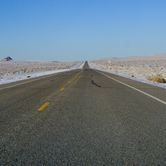 Winter in the American Southwest. Snow Covered Redrock Cliffs Driving Tourism