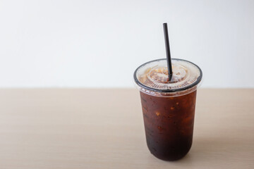 Iced Americano black coffee cup on the table in a coffee shop