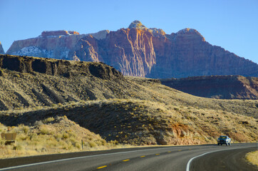 Winter in the American Southwest. Snow Covered Redrock Cliffs Driving Tourism