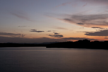 Naklejka premium Cloudy Weather with Sunrise | Horizon lake | The Shadow Of The Clouds On The Water | Brighter Colours | No People Japan lake