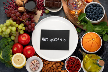 Selection of healthy food high in antioxidants on dark gray background. Clean eating concept.