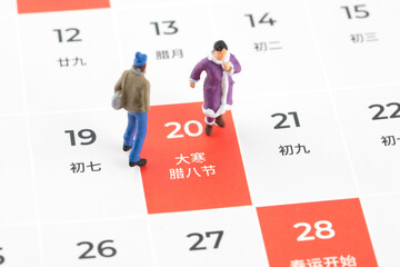 A doll wearing winter clothes on the Laba Festival calendar