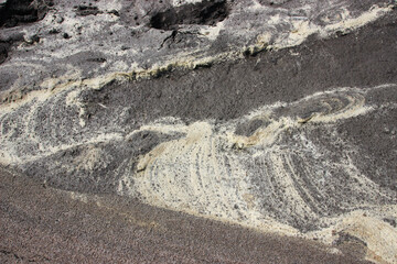 yellow streaks of small algae seeds on wet sand