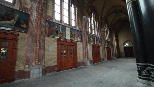 Wooden Doors With Paintings Above Inside The Brick Building Of Gouwekerk Church (Sint-Jozefkerk) In Gouda, Netherlands. - reveal