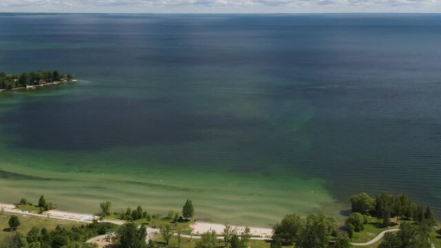 Aerial parallax shot revealing the beautiful coastline of Lake Simcoe in Ontario