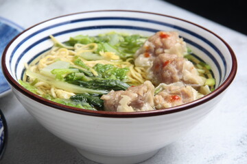 Freshly cooked noodle soup with steamed siomai