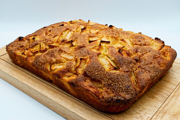 Fresh apple pie on a wooden table, white background