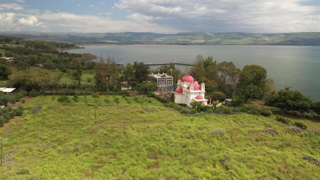 a daytime side drone shot of a church in tiberias sea of galilee