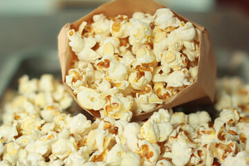 Close-up picture white popcorn in bag peper made of corn is a delicious food or snack to eat in the cinema use it as a background image.