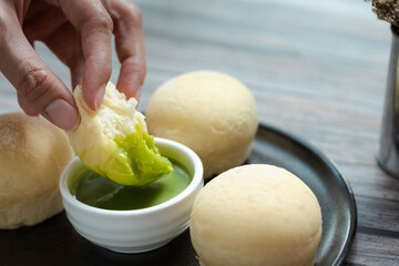 fluffy milk bread dipping into pandan kaya
