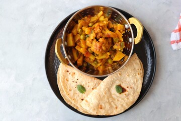 Aloo Gobi Mutter curry, cauliflower, and peas curry. Aloo Gobi masala. Served with wheat roti....