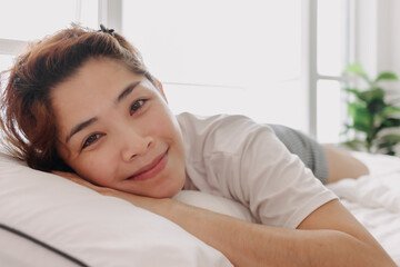 Close up of happy Asian woman just wake up in warm morning of summer.