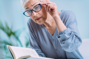 Glaucoma. Senior Woman a Reading Book, Having Ocular Tension. - obrazy, fototapety, plakaty