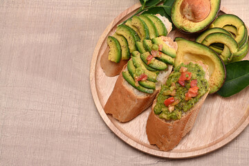 Avocado toast on wooden plate. Healthy food concept.