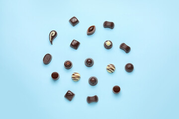 Sweet chocolate candies on color background