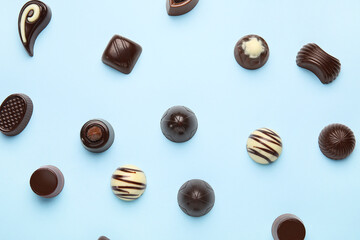Sweet chocolate candies on color background