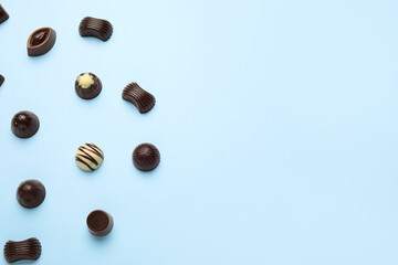 Sweet chocolate candies on color background