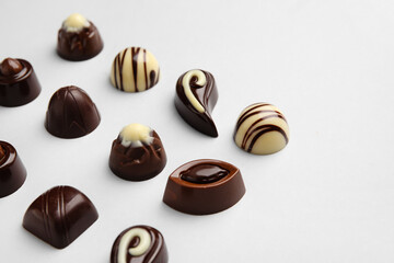 Sweet chocolate candies on light background