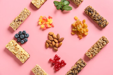 Composition with healthy cereal bars, berries and nuts on color background