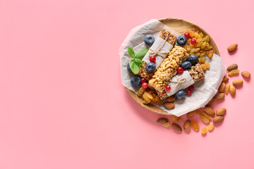 Plate with healthy cereal bars, berries and nuts on color background - Powered by Adobe