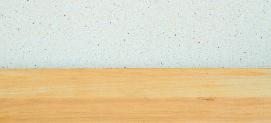 Background. A wooden table and a gray wall with black dots. Copy space
